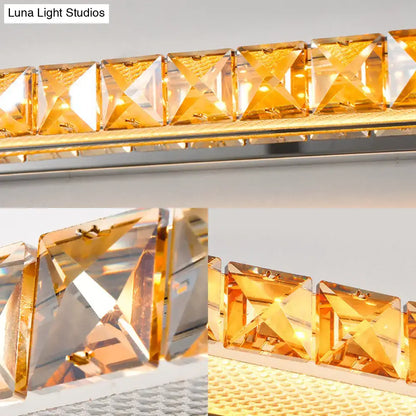 Contemporary crystal gold wall sconce with faceted amber squares and warm white led light for bathroom use