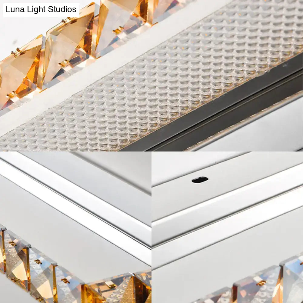 A contemporary crystal gold wall sconce with a sleek chrome frame warm white LEDs and amber crystal accents