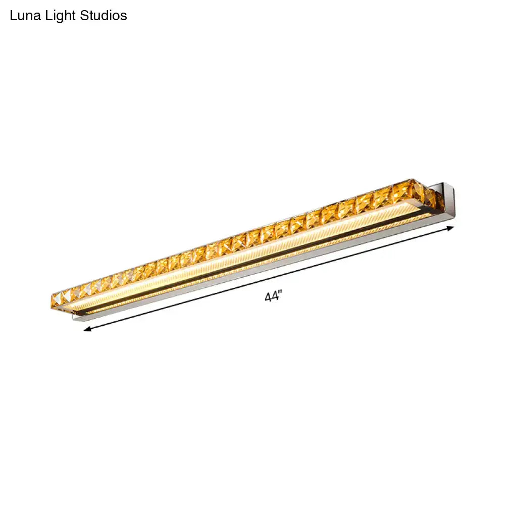 A sleek 44-inch contemporary crystal gold wall sconce with warm white LED and polished chrome frame for bathroom use