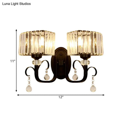 Elegant black wrought iron metal wall sconce with two crystal light fixtures and teardrop crystals, ideal as a wall lamp