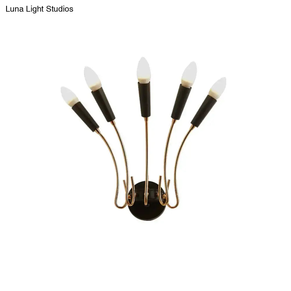 Contemporary metal sconce with brass finish and five black capped frosted glass bulbs for living room lighting
