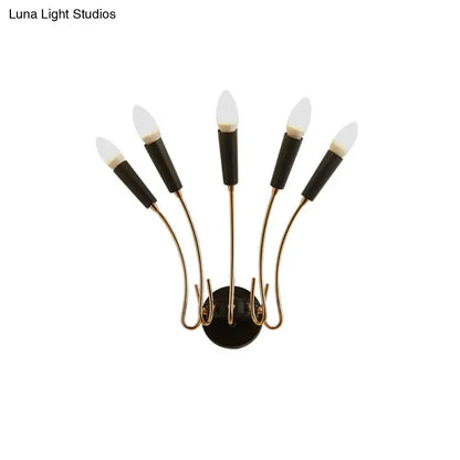 Contemporary metal sconce with brass finish and five black capped frosted glass bulbs for living room lighting