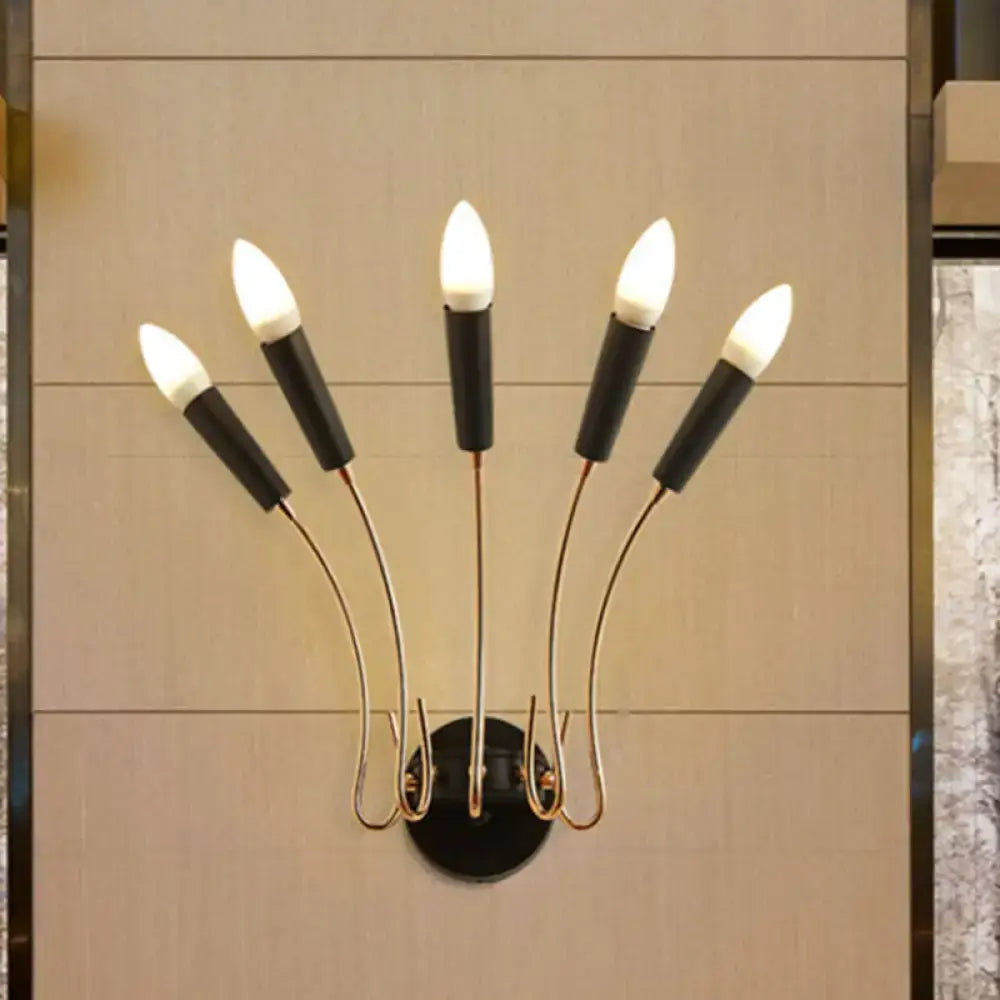 Contemporary metal sconce with five curved gold-toned arms and black bases holding candle-style bulbs for living room