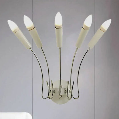Modern five-light contemporary metal sconce with curved chrome arms and frosted candle-style bulbs for living room