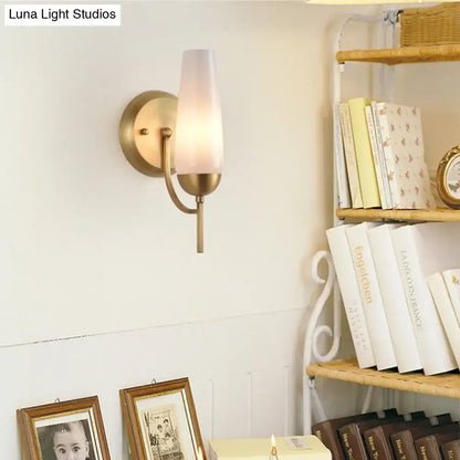 Contemporary gold brass wall sconce with frosted opal conical glass shade for bedroom lighting