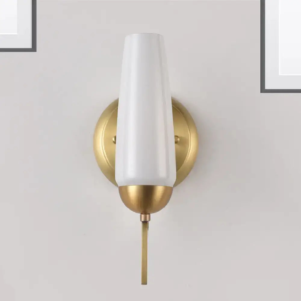 Contemporary gold and opal conical wall sconce with gold-toned metal and white tapered glass shade for bedroom lighting