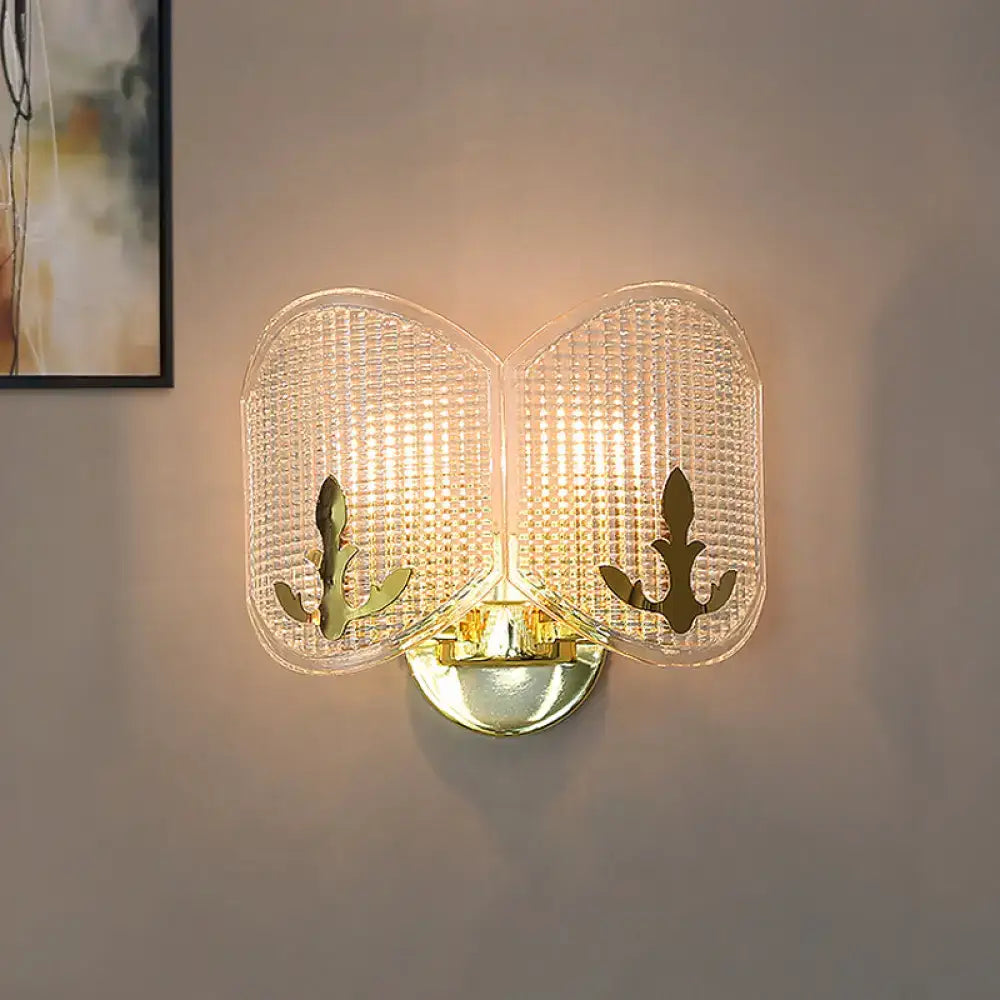 Contemporary gold arc light fixture with two translucent glass panels featuring anchor cutouts for living room use