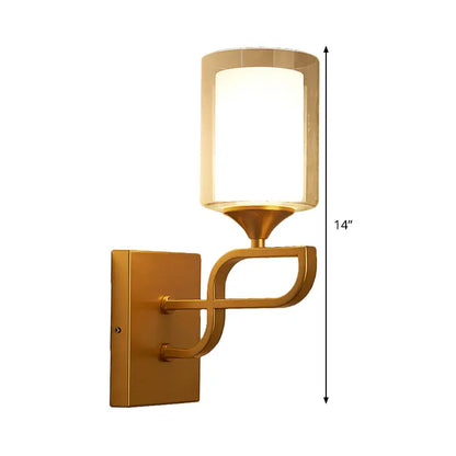 Contemporary gold armed sconce light with cylindrical frosted glass shade and elegant curved arm design for bedroom
