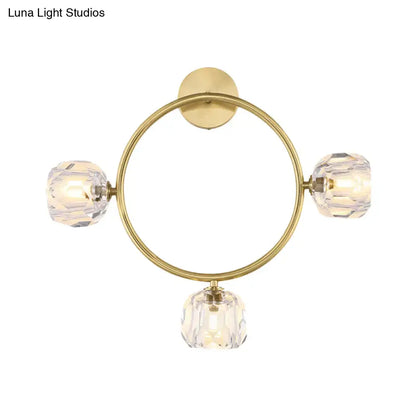 Contemporary gold brass wall light fixture with three faceted crystal globes for elegant bedroom lighting