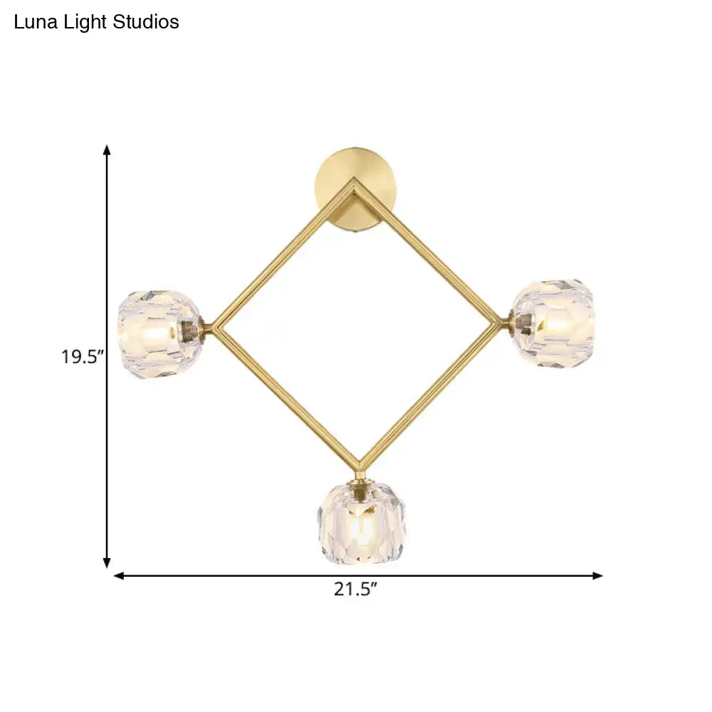 Contemporary gold brass wall light fixture with diamond-shaped design and three faceted crystal globe lights for bedroom