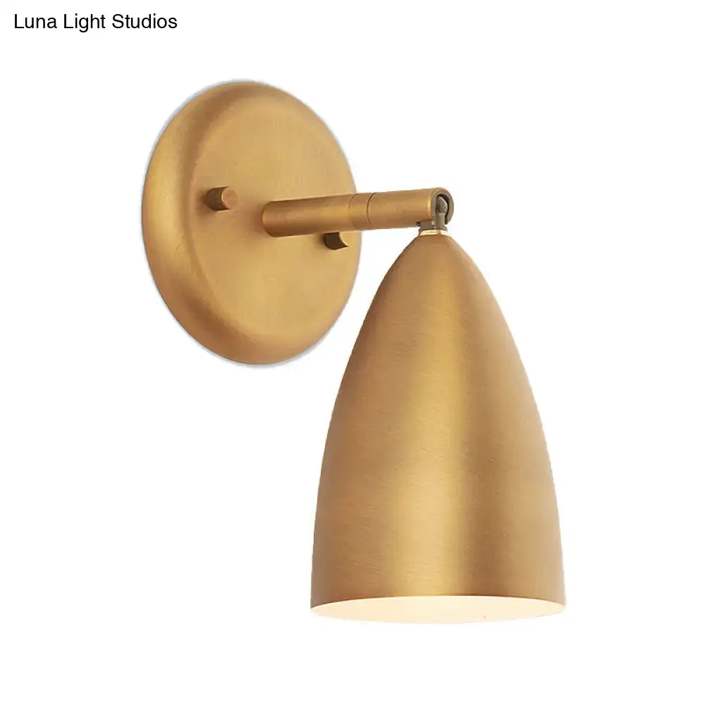 Brass-finished contemporary gold conical wall mount lamp with sleek shade and circular mounting plate for bedroom spotlight