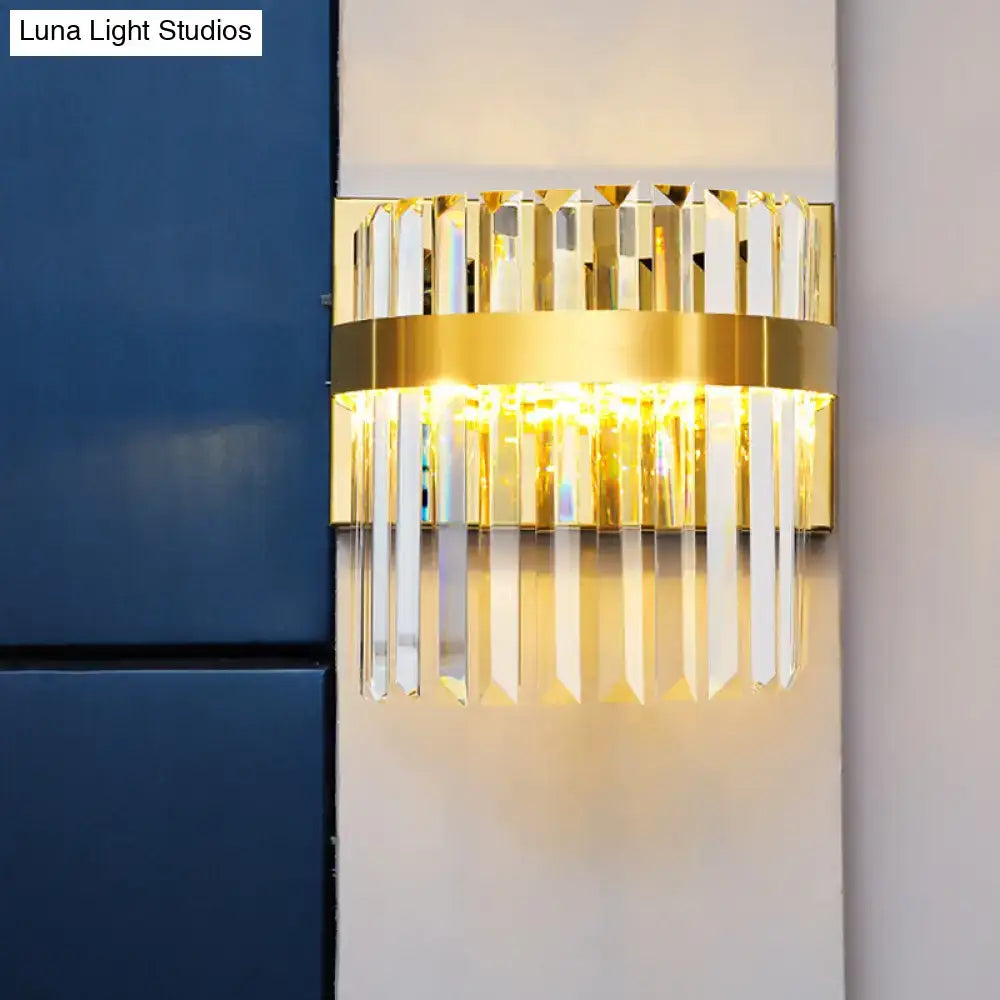 Contemporary gold crystal demilune cylinder wall light with vertical prisms and illuminated central band for living room