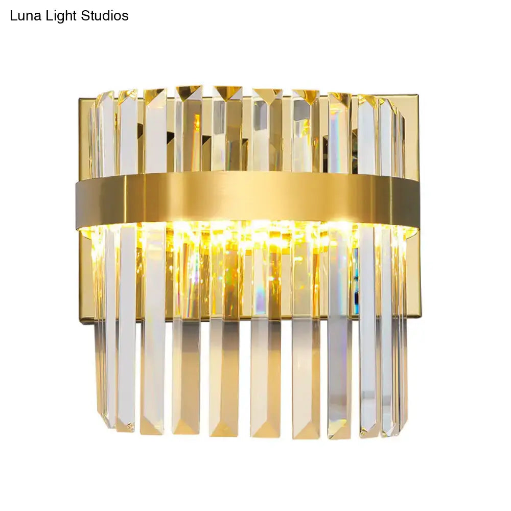 Contemporary gold crystal demilune cylinder wall light with vertical crystal prisms and central illuminated band for living room