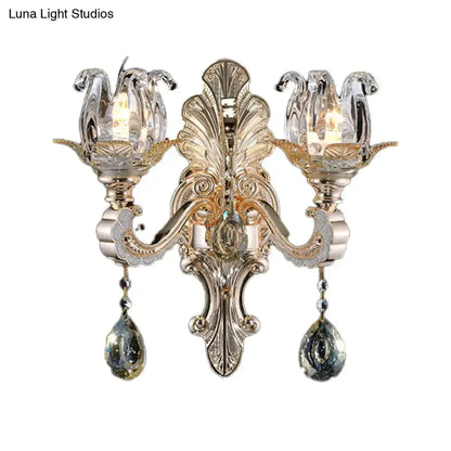 Ornate gold-toned wall lamp with crystal drop tulip-shaped shades designed as a contemporary light fixture