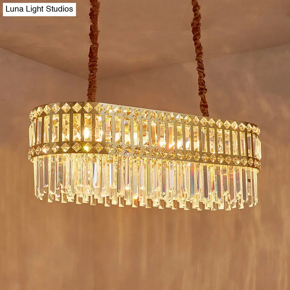 Contemporary gold-toned oval light fixture with clear crystal prisms for dining area use with led incandescent fluorescent bulbs