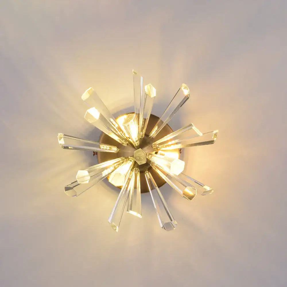 Contemporary gold crystal wall sconce with clear faceted rods and brass base, bulb base compatible, 18 inches tall