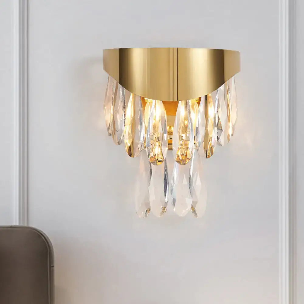 Contemporary gold crystal teardrop wall sconce featuring gold-toned metal and cascading clear crystal droplets for bedroom lighting