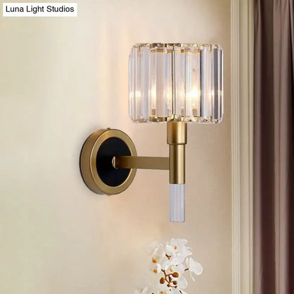 Contemporary gold wall mount lamp with cylindrical crystal shade and clear glass stem for living room lighting
