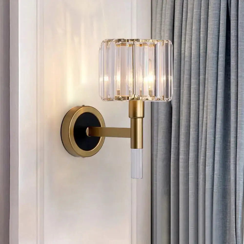 Contemporary gold wall mount lamp with cylindrical crystal shade and clear glass stem for living room sconce