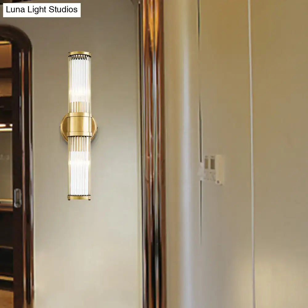 Contemporary gold crystal wall sconce light fixture with gold metal frame and frosted glass panels for living room