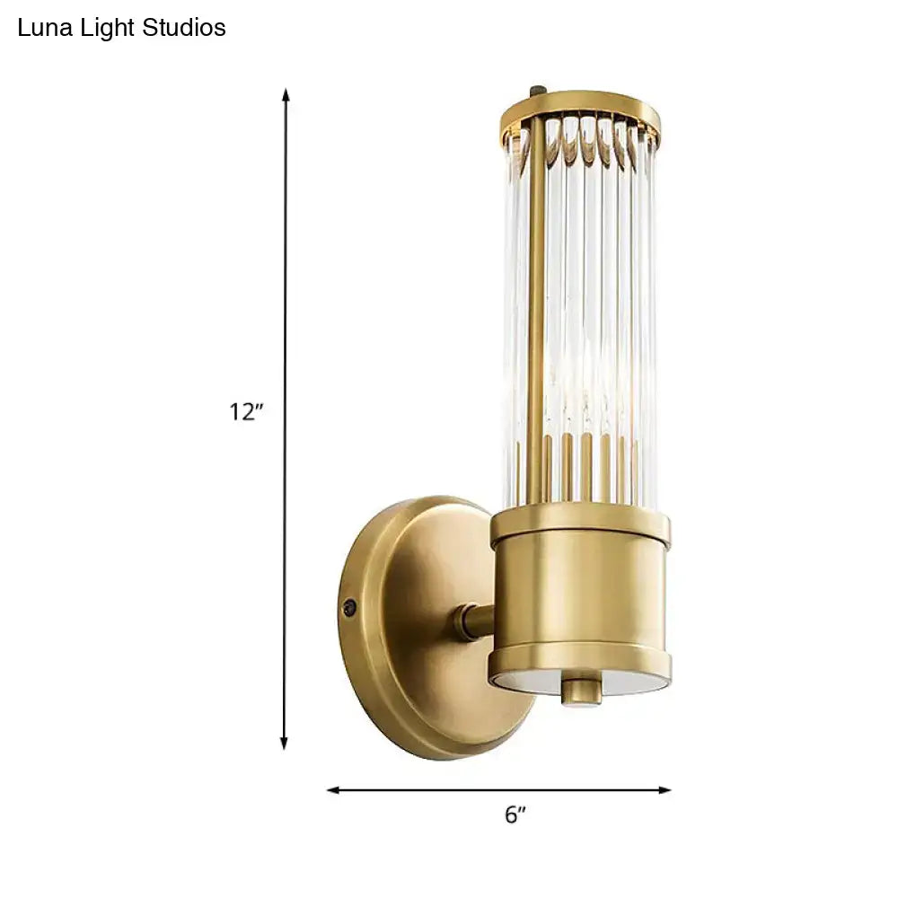 Contemporary gold crystal wall sconce light fixture with vertical rods and cylindrical glass shade for living room