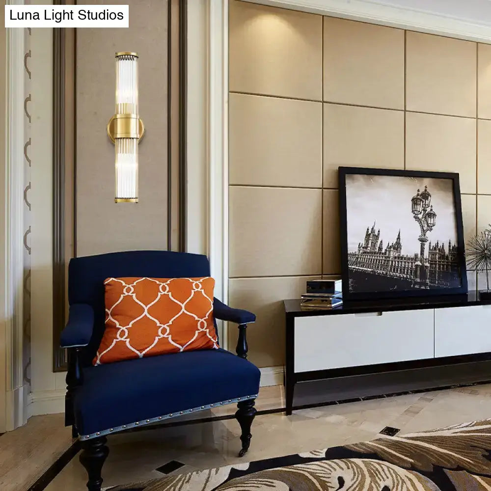Contemporary gold crystal wall sconce light fixture with vertical frosted glass panels for living room lighting
