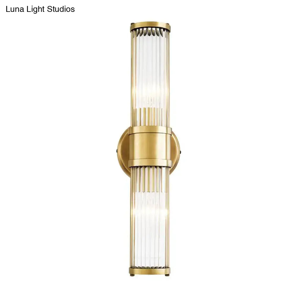 Contemporary gold crystal wall sconce light fixture with vertical ribbed glass panels for living room lighting