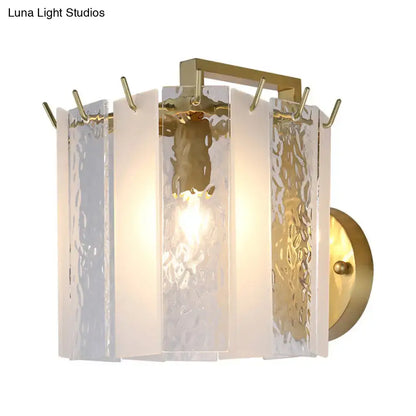 Contemporary gold drum wall sconce light with textured translucent glass panels and modern geometric design for bedroom