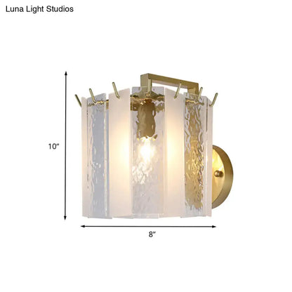 Contemporary gold drum wall sconce light with textured translucent white glass panels in a rectangular frame for bedroom