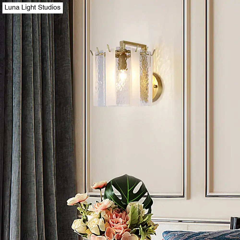 Contemporary gold drum wall sconce light with textured glass panels and central bulb for bedroom lighting