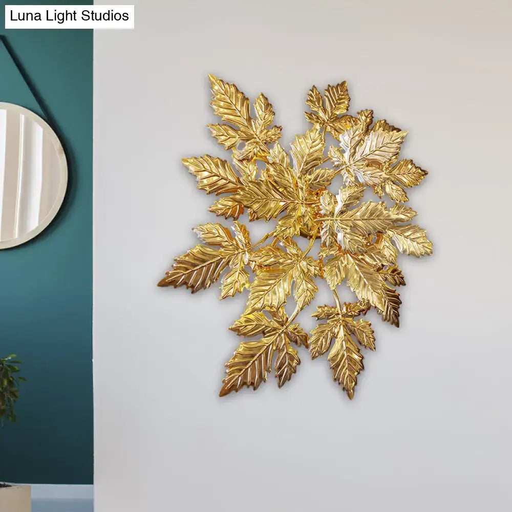 Contemporary gold finish maple leaf wall mount sconce featuring a golden metallic leaf sculpture for living room decor