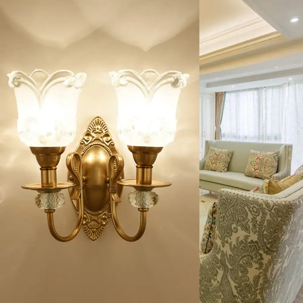 Contemporary gold wall lamp with frosted glass petal shades featuring floral detailing and crystal accents for bedroom