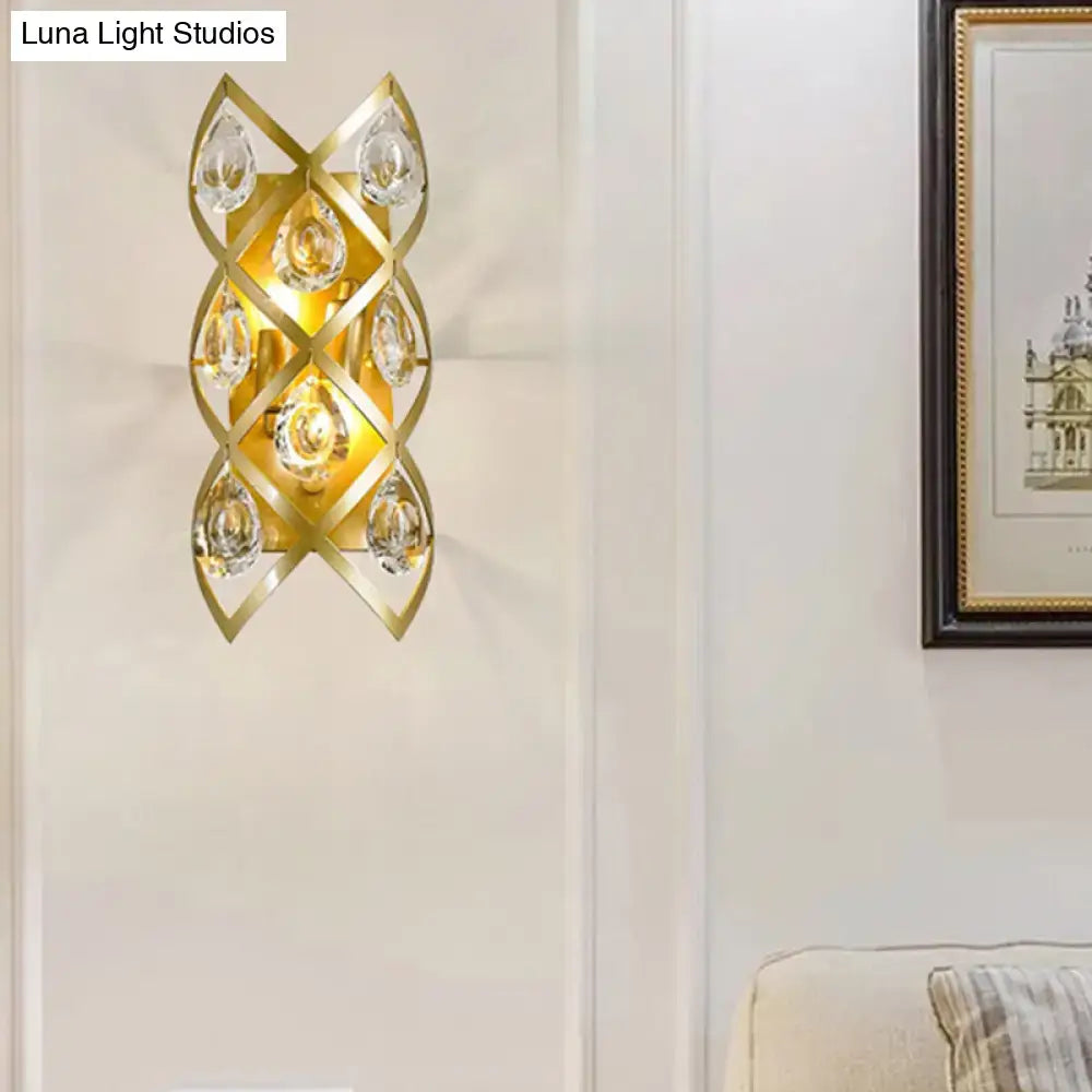 Contemporary gold geometric teardrop sconce with clear crystal accents for a living room light fixture