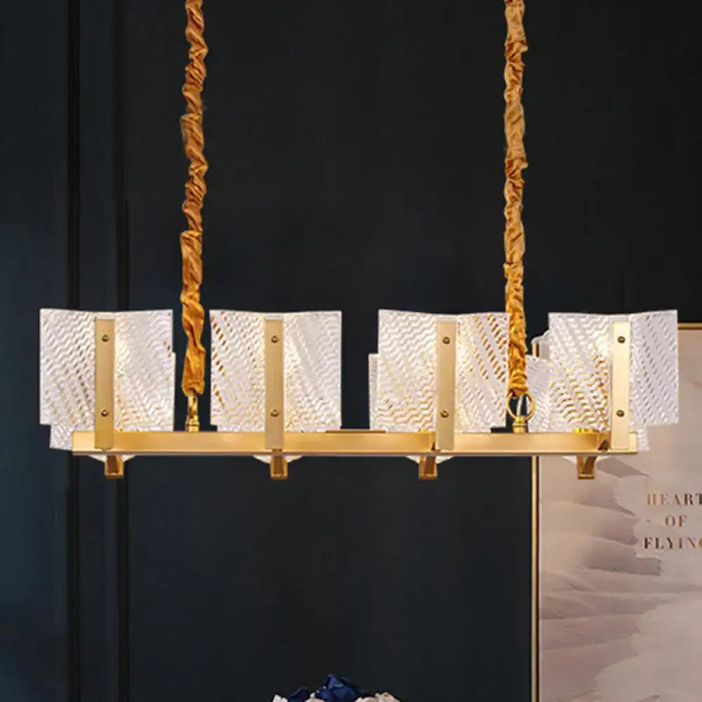 Contemporary gold linear chandelier light fixture with twisted rope chains and five rectangular square glass panels