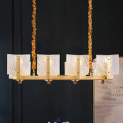 Contemporary gold linear chandelier light fixture with twisted rope chains and five rectangular square glass panels