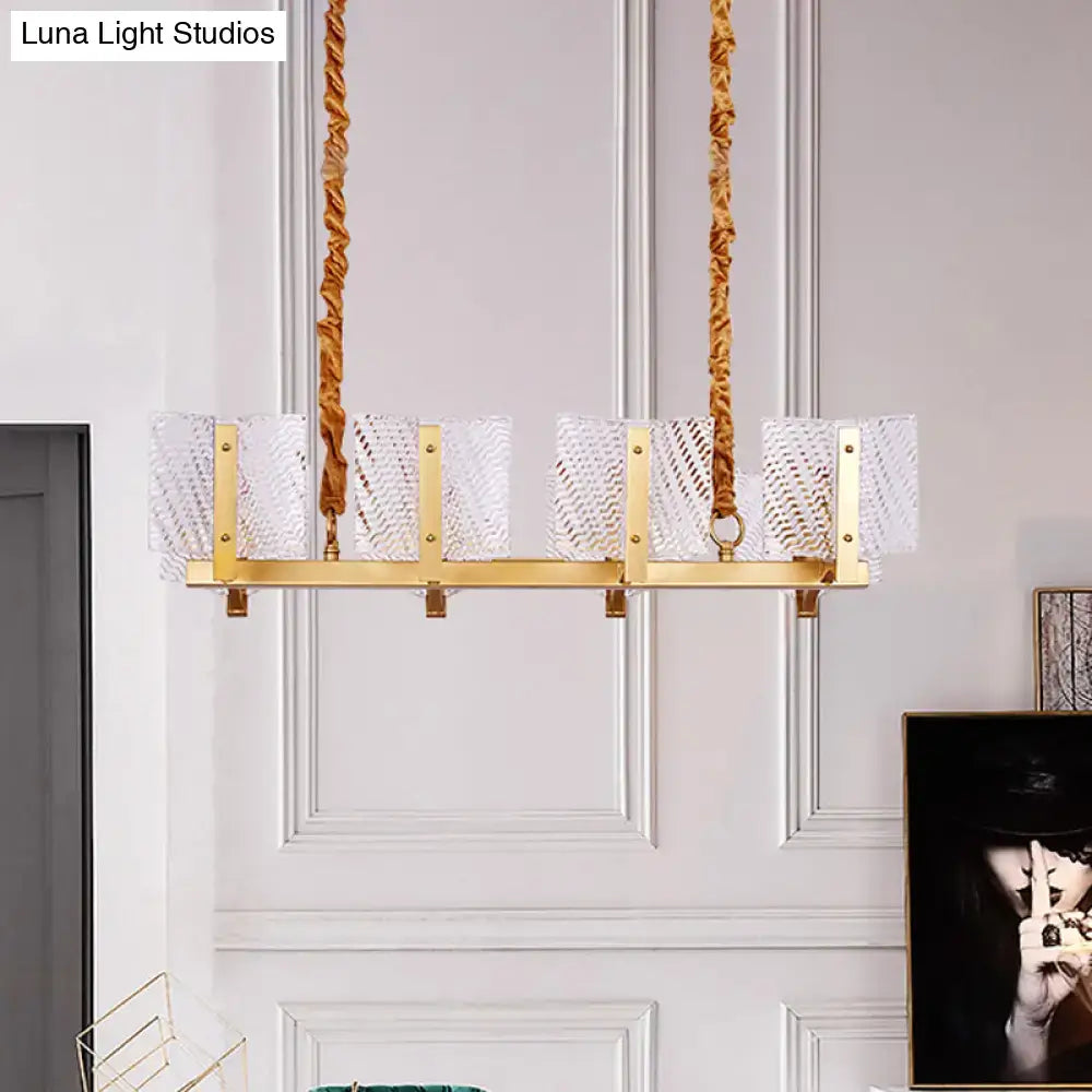 Contemporary gold linear chandelier light fixture with five clear textured glass shades and square glass panel design