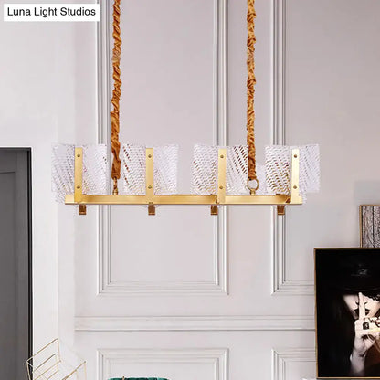 Contemporary gold linear chandelier light fixture with five clear textured glass shades and square glass panel design