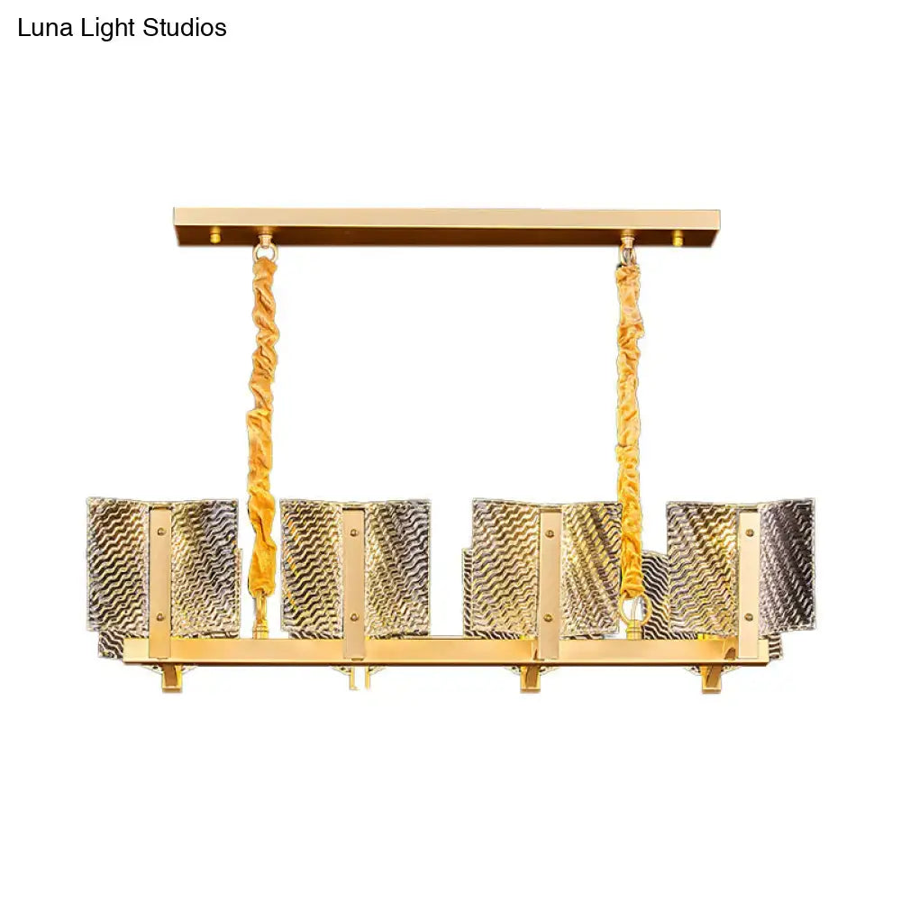 Contemporary gold linear chandelier light fixture with square glass panels and twisted rope-like chains for dining room
