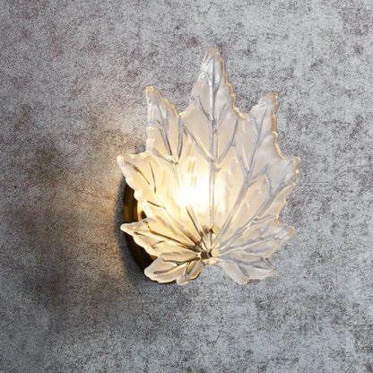 Contemporary gold maple leaf bedroom wall light with translucent frosted glass and warm crystal glow sconce