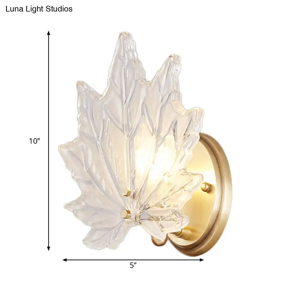 Contemporary gold maple leaf wall light with clear glass crystal sconce and gold-toned metal base for maple leaf bedroom