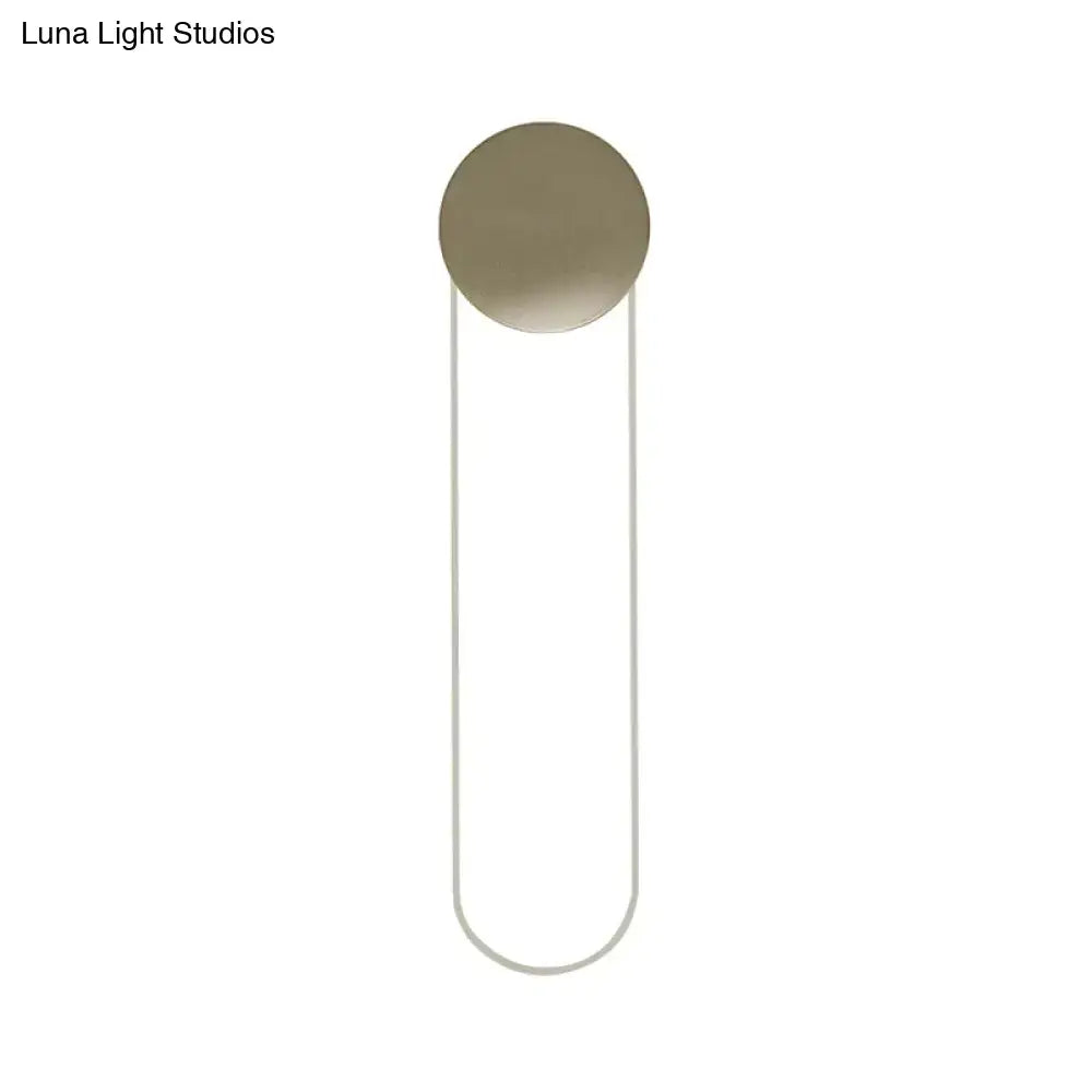 Contemporary gold oblong bedroom wall light fixture with a minimalist brushed brass circular head and curved metal frame 110v 120v