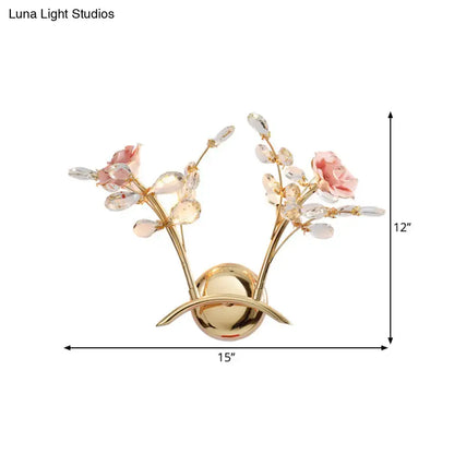 Contemporary gold wall lamp with pink rose crystal design featuring bulb base and bulb included for bedroom use