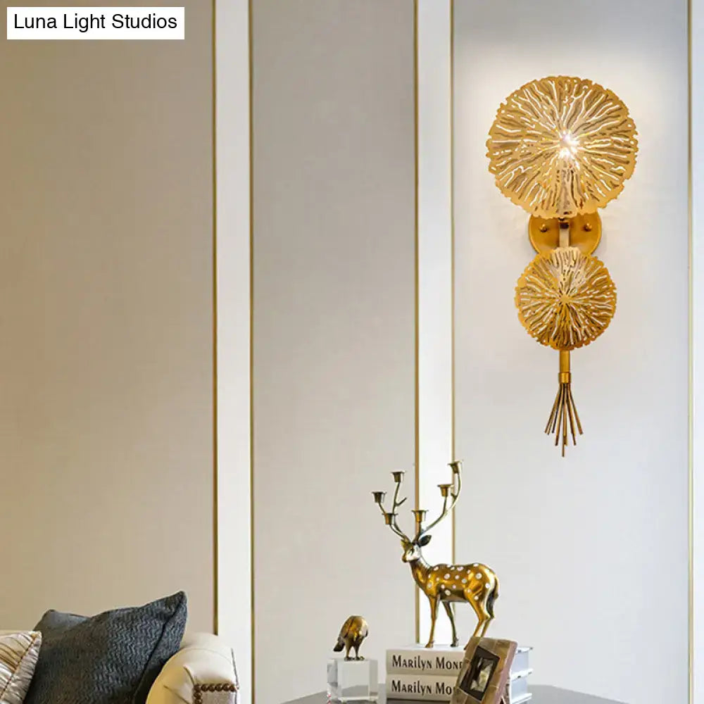 Contemporary gold sunburst wall light with two layered circular shades and tassel designed for e14 bulb use