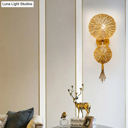 Contemporary gold sunburst wall light with two layered circular shades and tassel designed for e14 bulb use