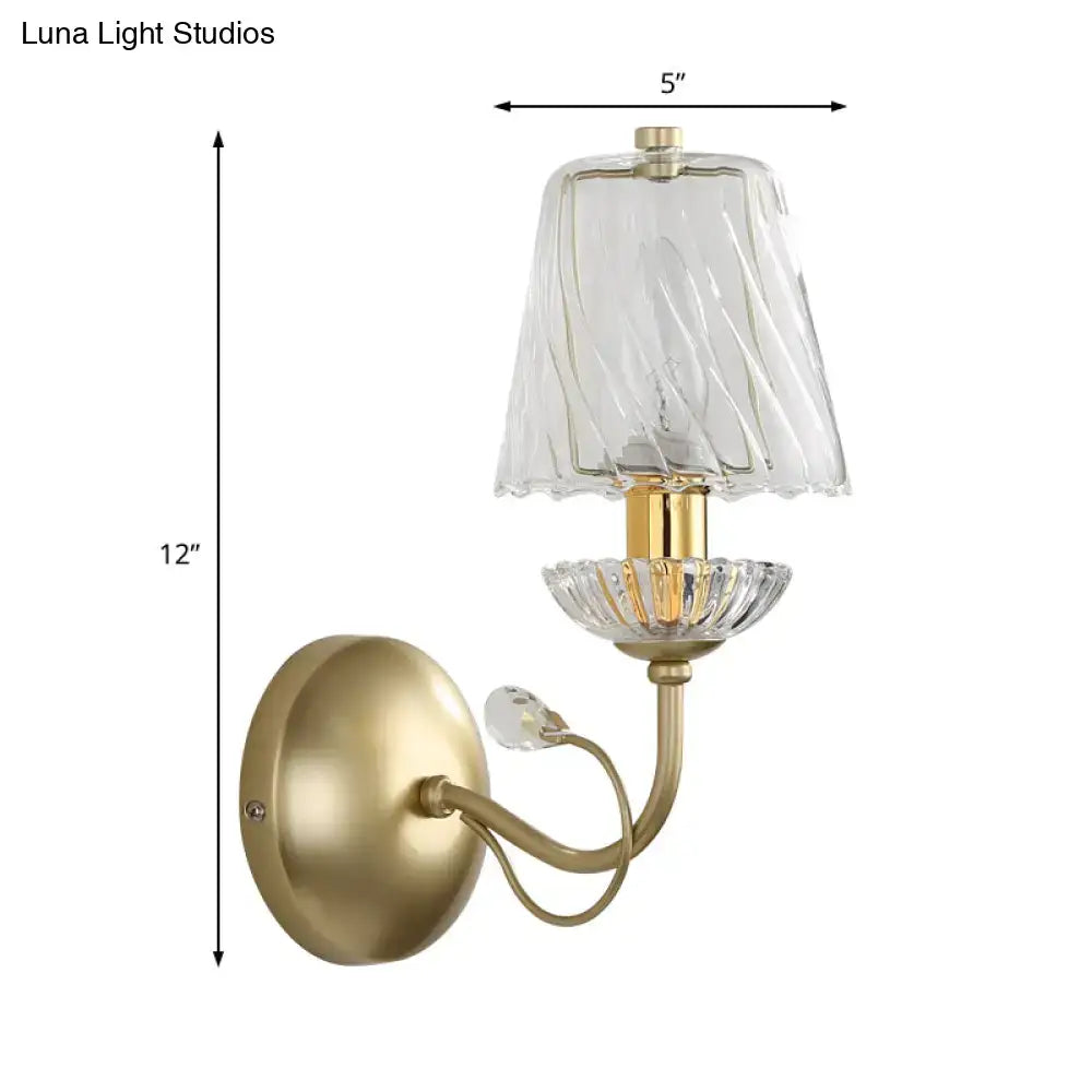 Antique brass wall light with twisted clear glass shade and crystal accents featuring an e12 bulb base
