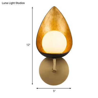 Contemporary gold teardrop sconce light with textured finish black base and illuminated frosted glass for bedroom