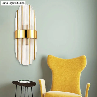 Contemporary gold wall light with vertical frosted glass tubes clear crystal shade and central metallic band for living room