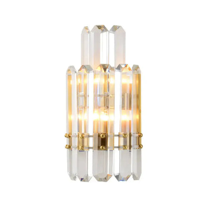 Contemporary gold wall sconce with clear crystal prisms and gold-toned metal accents for dining room lighting