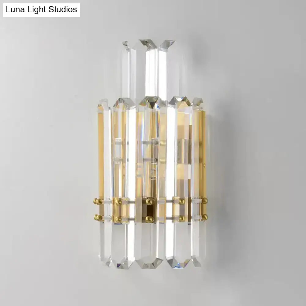 Contemporary gold wall sconce with clear crystal prisms and acrylic rods for elegant dining room lighting