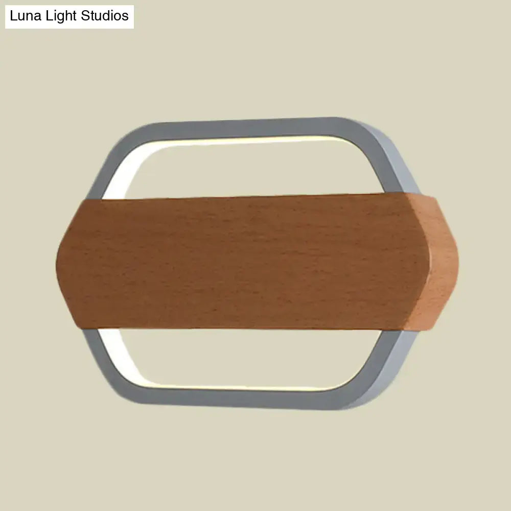 A modern hexagonal wall lamp with a silver metal frame and warm natural color temperature direct wired electric design
